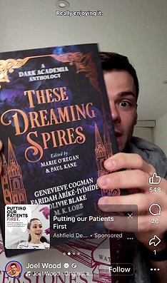 screenshot showing Joel Wood holding a copy of These Dreaming Spires, edited by Marie O'Regan and Paul Kane, close to the camera