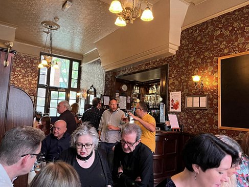 Authors and friends from The Other Side of Never signing in a pub. Front left: Cavan Scott, Barbie Wilde, Georg Kastannus, Anna Smith Spark, middle, Lavie Tidhar