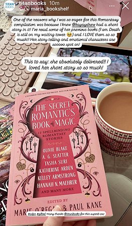 photograph of a copy of The Secret Romantic's Book of Magic, edited by Marie O'Regan and Paul Kane, lying on another book and a computer mouse. In the background is a keyboard, a pink box, a tablet and a mug of tead. Text reads: One of the reasons why I was so eager for this Romantasy compilation was because I knew @kayaydrew had a short story in it! I've read some of her previous books (I Am Death is still on my waiting tower) and i LOVE them, so so much! Her story telling and emotional characters are sooooo spot on! This is to say: she absolutely delivered! I loved her short story so so much!