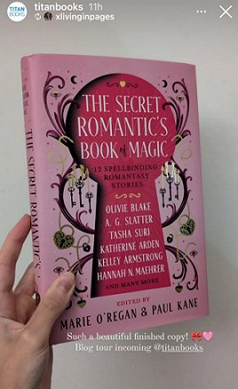photograph of a woman's hand holding a copy of The Secret Romantic's Book of Magic, edited by Marie O'Regan and Paul Kane, up against a white wall. Text reads: Such a beautiful finished copy! Blog tour incoming @titanbooks