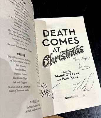 photograph showing the title page of a copy of Death Comes at Christmas, edited by Marie O'Regan and Paul Kane, signed by Russ Thomas, Tom Mead, Marie O'Regan and Paul Kane