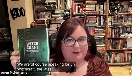 screenshot showing Lauren McMenemy of the BFS holding up a copy of Beyond & Within: Witchcraft, edited by Marie O'Regan and Paul Kane